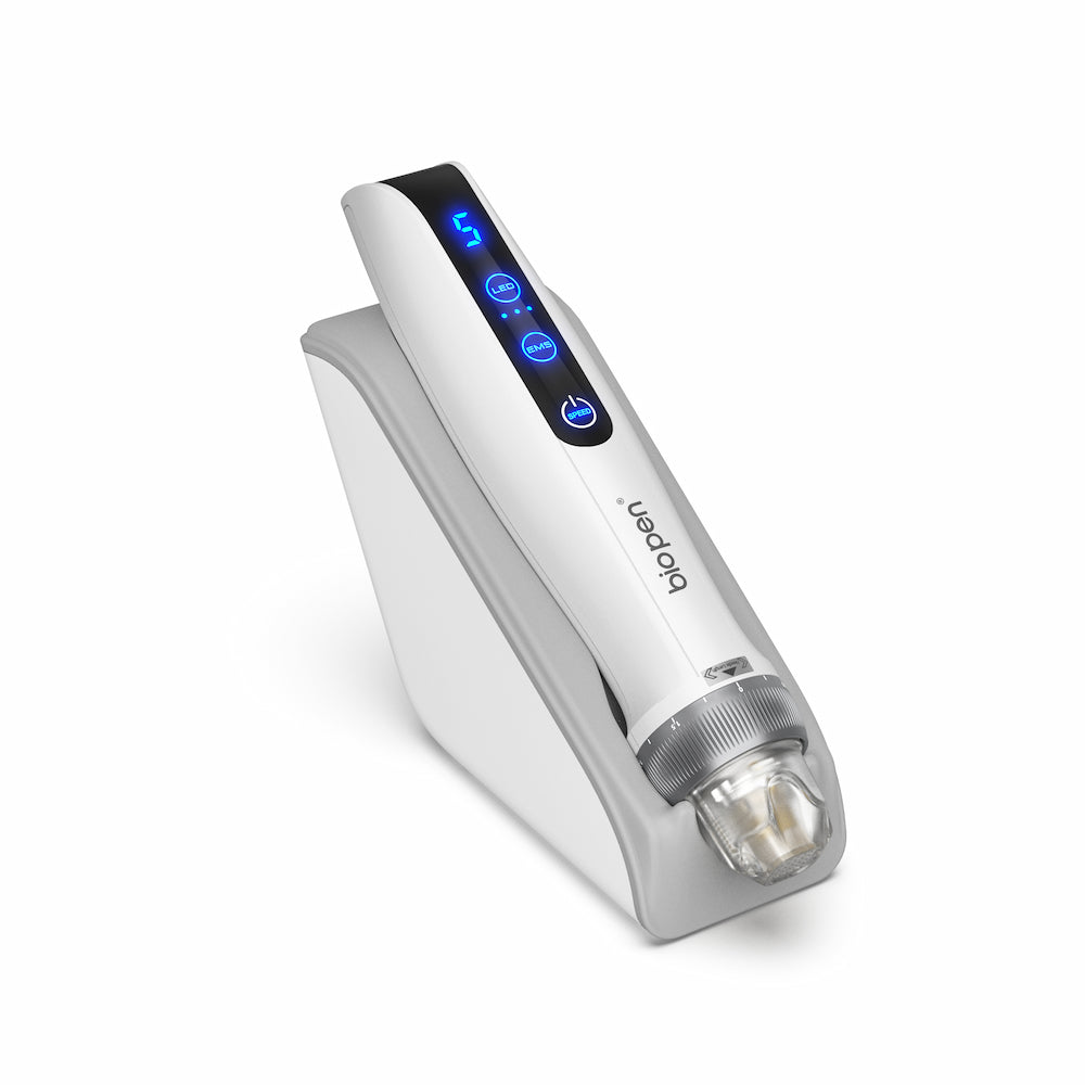 White BioPen Q2 microneedling pen placed on a gray stand, with blue LED display and transparent needle module at the front.
